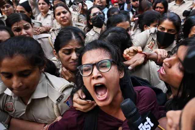 Crowds throng New Delhi and wave Indian flags amid escalating protests